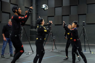 Three girls and Joe Gomez wearing motion capture technology suits