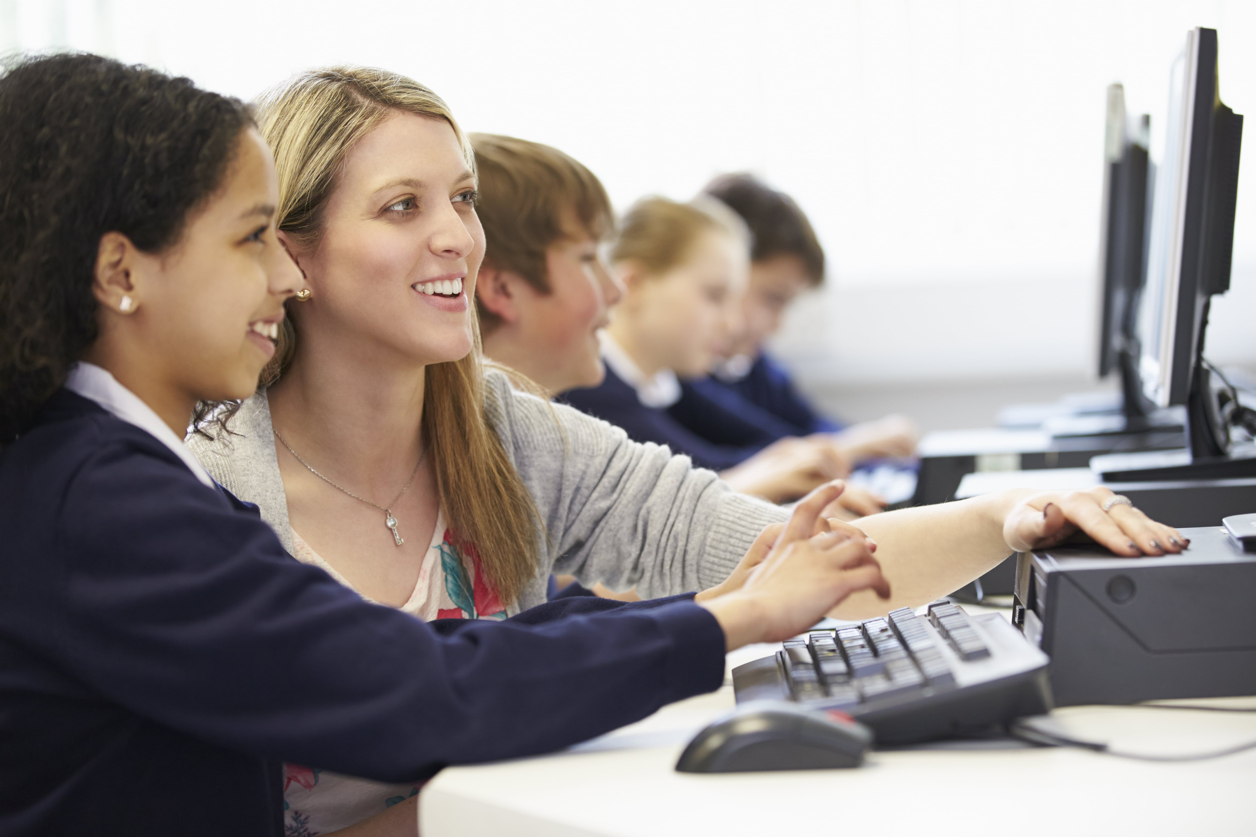Image of pupils and teacher doing research on the computer.